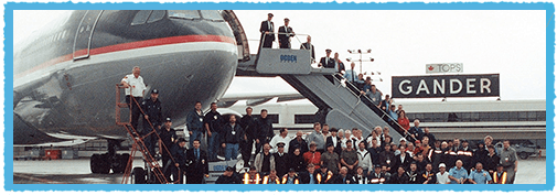 Gandar passengers posing for photo in front of plane